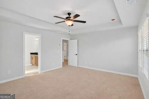 a view of a livingroom with a ceiling fan and window