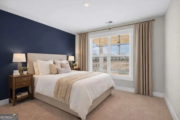 a bedroom with a bed and a window
