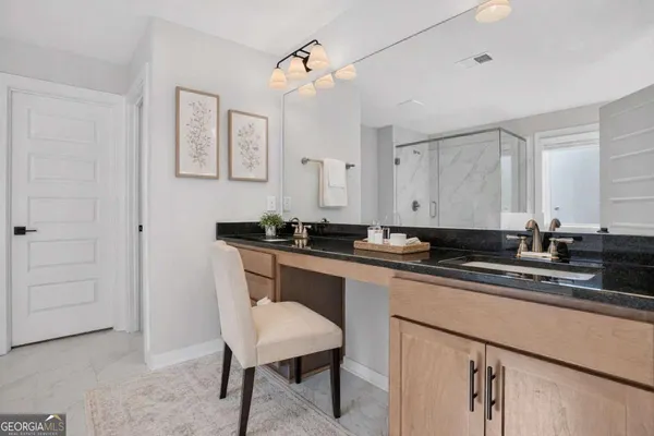 a kitchen with a sink cabinets and wooden floor
