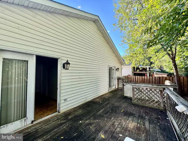 a view of a wooden chairs on the deck