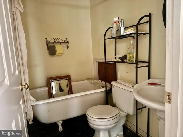 a bathroom with a sink toilet and mirror