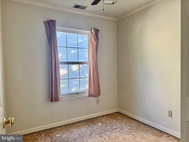 a view of room with window and hardwood floor