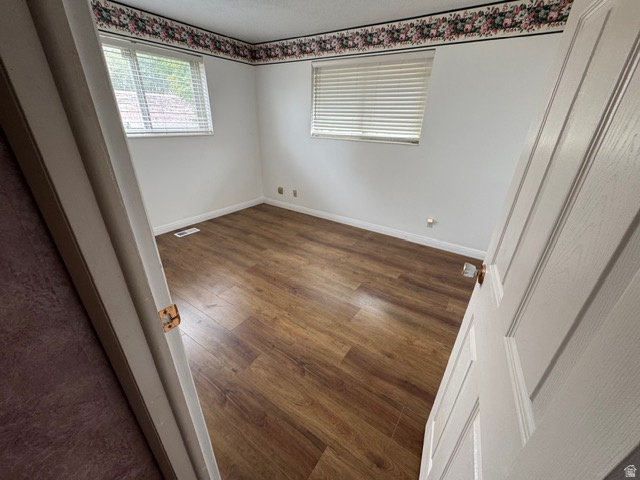 588 North 4500 West West Point, UT 84015 - Photo 18 of 61 Unfurnished bedroom with dark wood-style laminate floors and baseboards