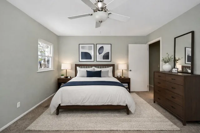 a bedroom with a large bed and a chandelier