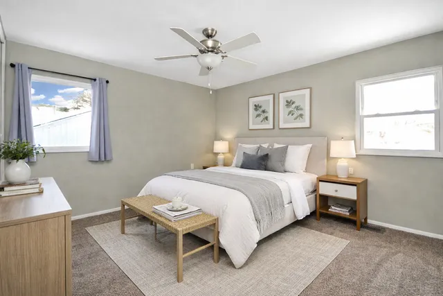 a bedroom with a bed and a window