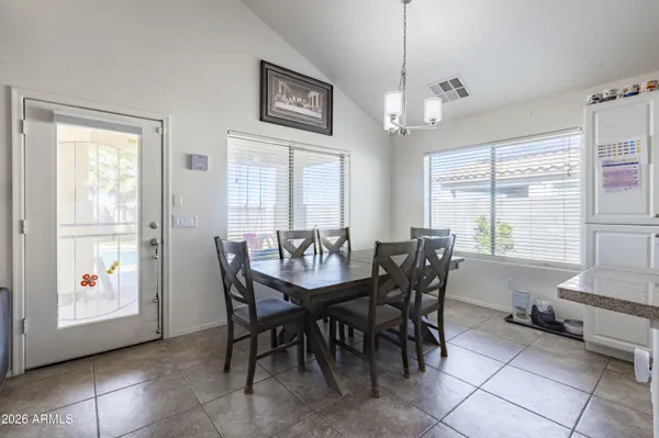 a view of a dining room with furniture large windows and wooden floor