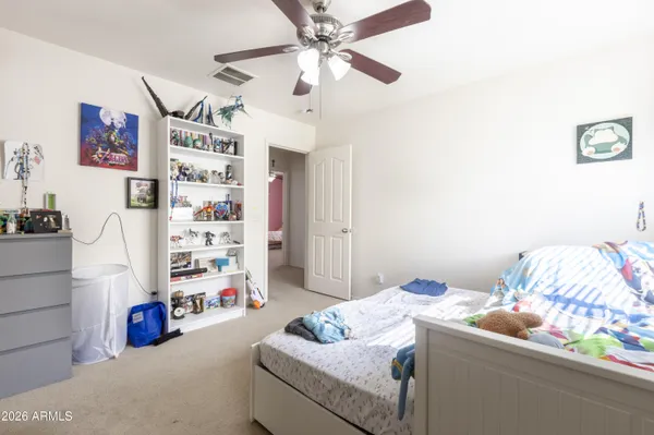 a bedroom with bed and a couch