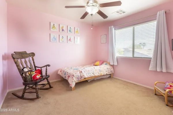 a bedroom with a bed chair and window