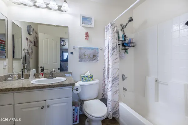 a bathroom with a granite countertop toilet sink and shower