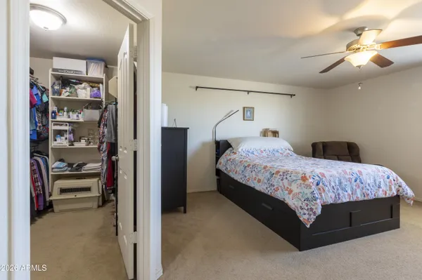 a bedroom with a bed and a book shelf