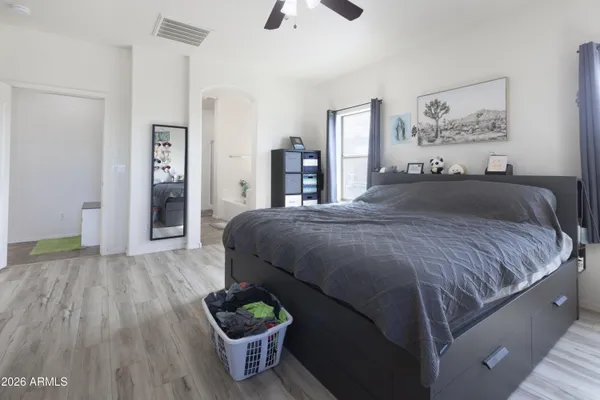 a bedroom with a bed and a chandelier