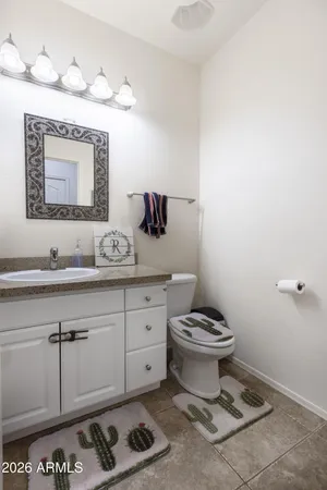 a bathroom with a toilet a sink and mirror