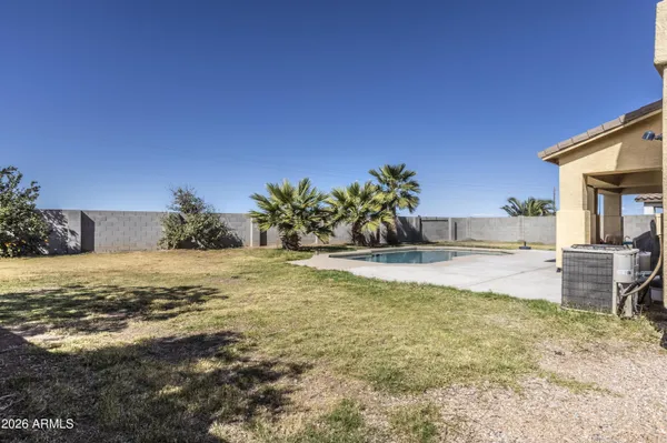 a view of a swimming pool with a yard