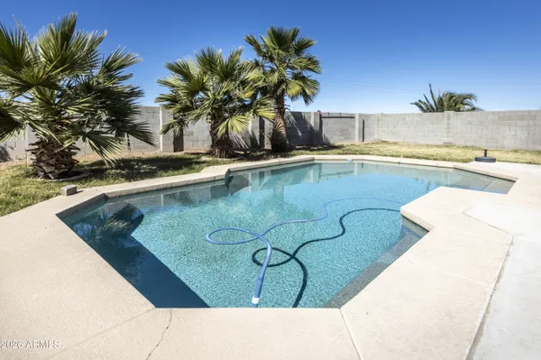 a view of swimming pool with a table and chairs