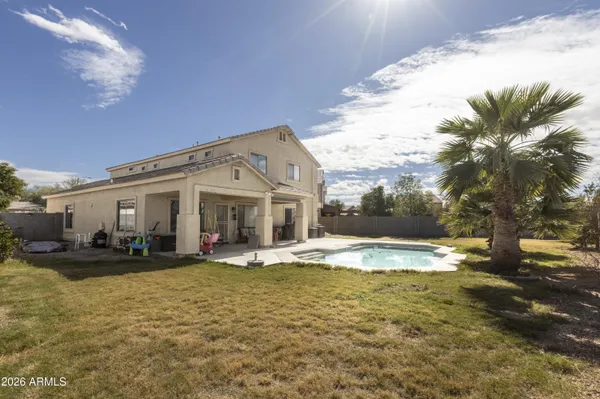 a view of a house with swimming pool and sitting area