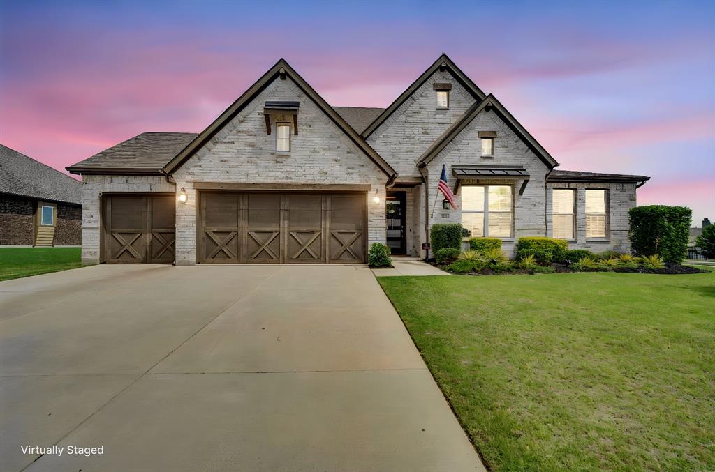 a front view of a house with a yard and garage