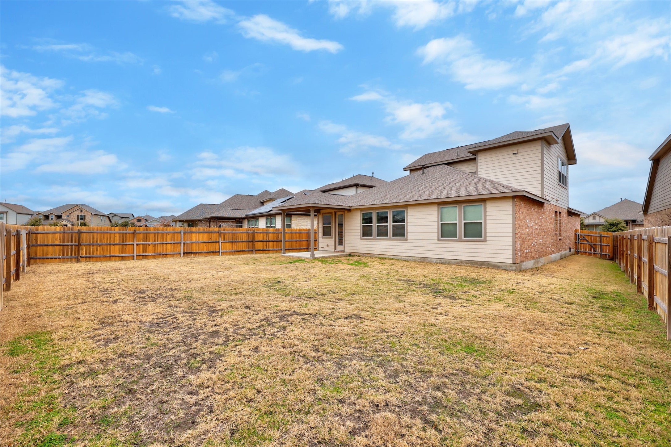 307 Simmental Loop Hutto, TX 78634 - Photo 32 of 34 A spacious, fenced backyard offers private outdoor living and room for recreation.