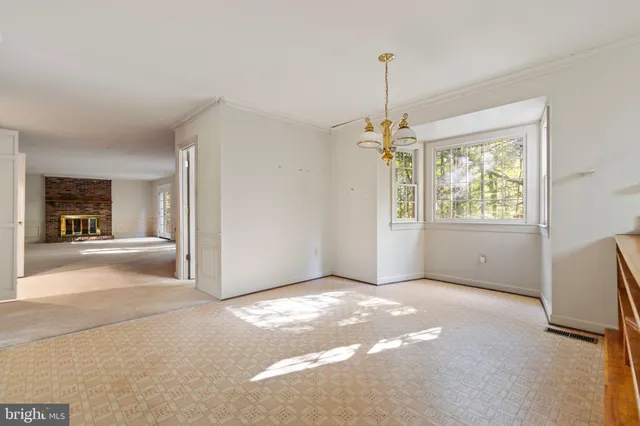 a view of a livingroom with window wooden floor and door