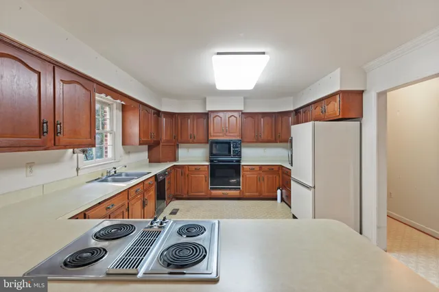 a kitchen with a refrigerator and a stove