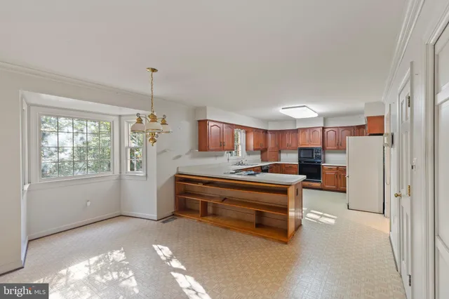 a living room with furniture a chandelier and a window