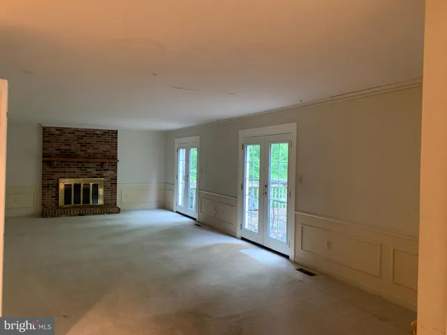 a view of a livingroom with an empty space and a fireplace
