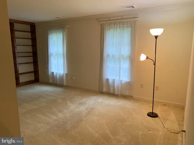 a view of an empty room with a fireplace