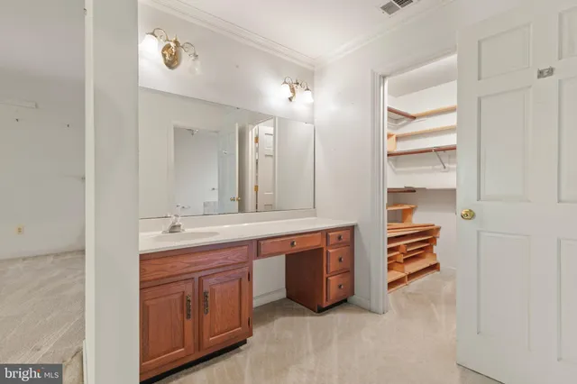 a spacious bathroom with a double vanity sink a and a large mirror