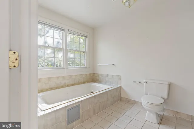 a white bath tub sitting next to a toilet