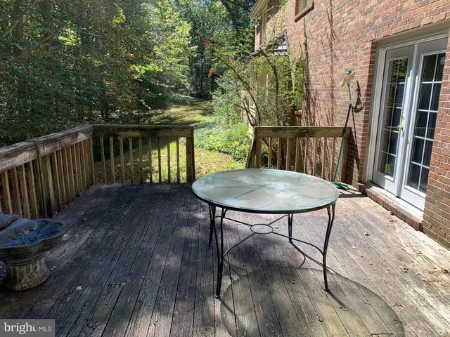 a view of a deck with table and chairs and wooden floor