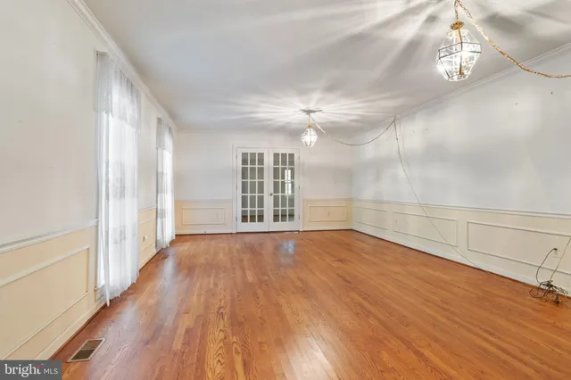 wooden floor in an empty room with a window