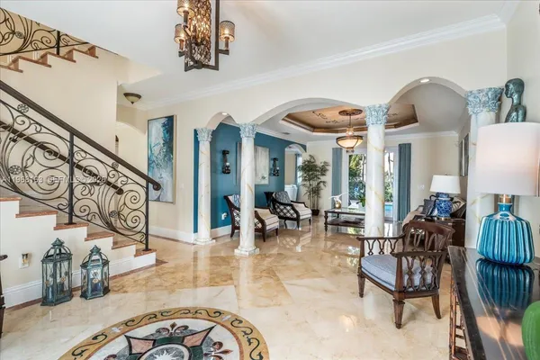 a dining room with furniture a chandelier and wooden floor
