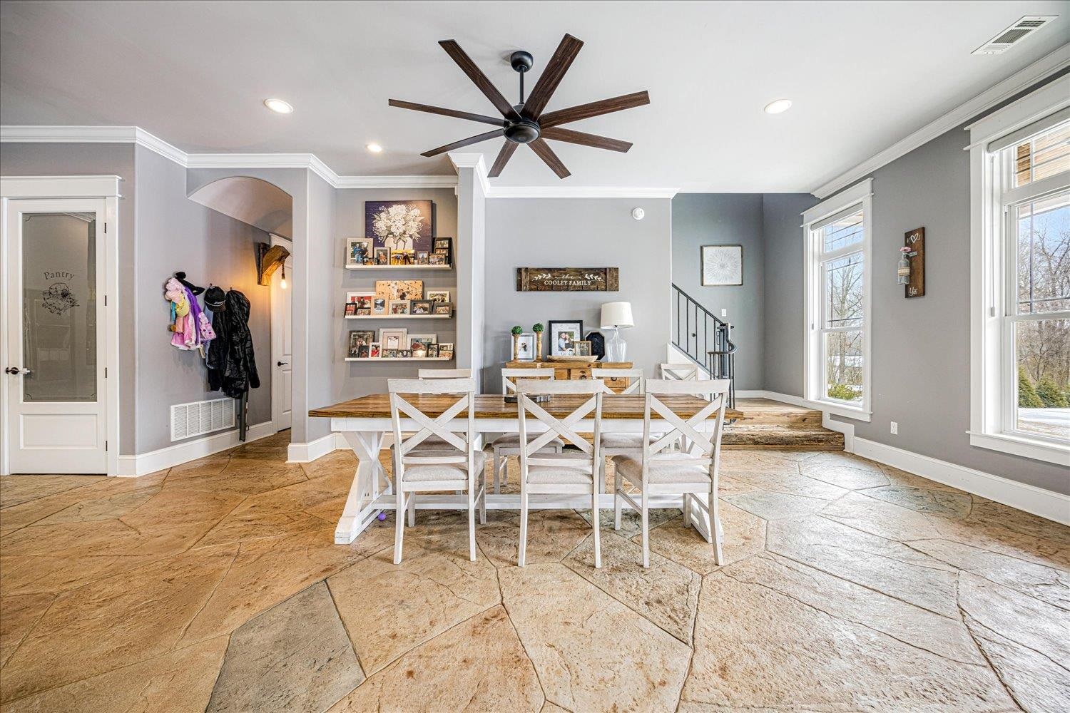 897 Burrowtown Road Mason, TN 38049 - Photo 11 of 36 Dining space with a ceiling fan, crown molding, light stone finish floors, and recessed lighting