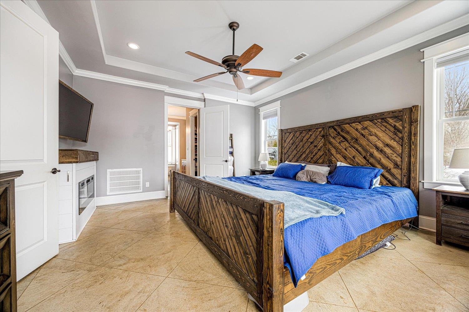 897 Burrowtown Road Mason, TN 38049 - Photo 14 of 36 Bedroom featuring recessed lighting, a raised ceiling, a ceiling fan, light tile patterned floors, and crown molding