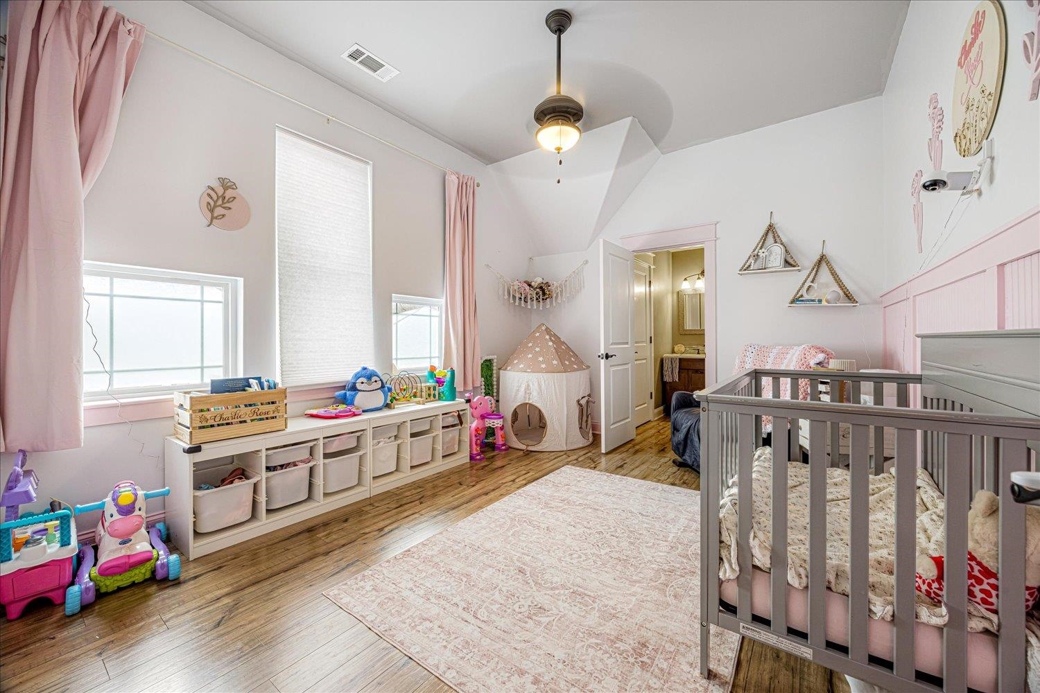 897 Burrowtown Road Mason, TN 38049 - Photo 20 of 36 Bedroom featuring wood-type flooring, a nursery area, and a ceiling fan
