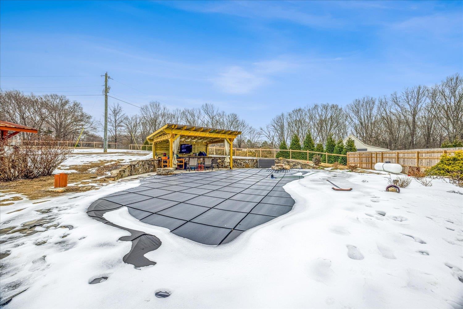 897 Burrowtown Road Mason, TN 38049 - Photo 30 of 36 Snowy yard with a pergola and a patio