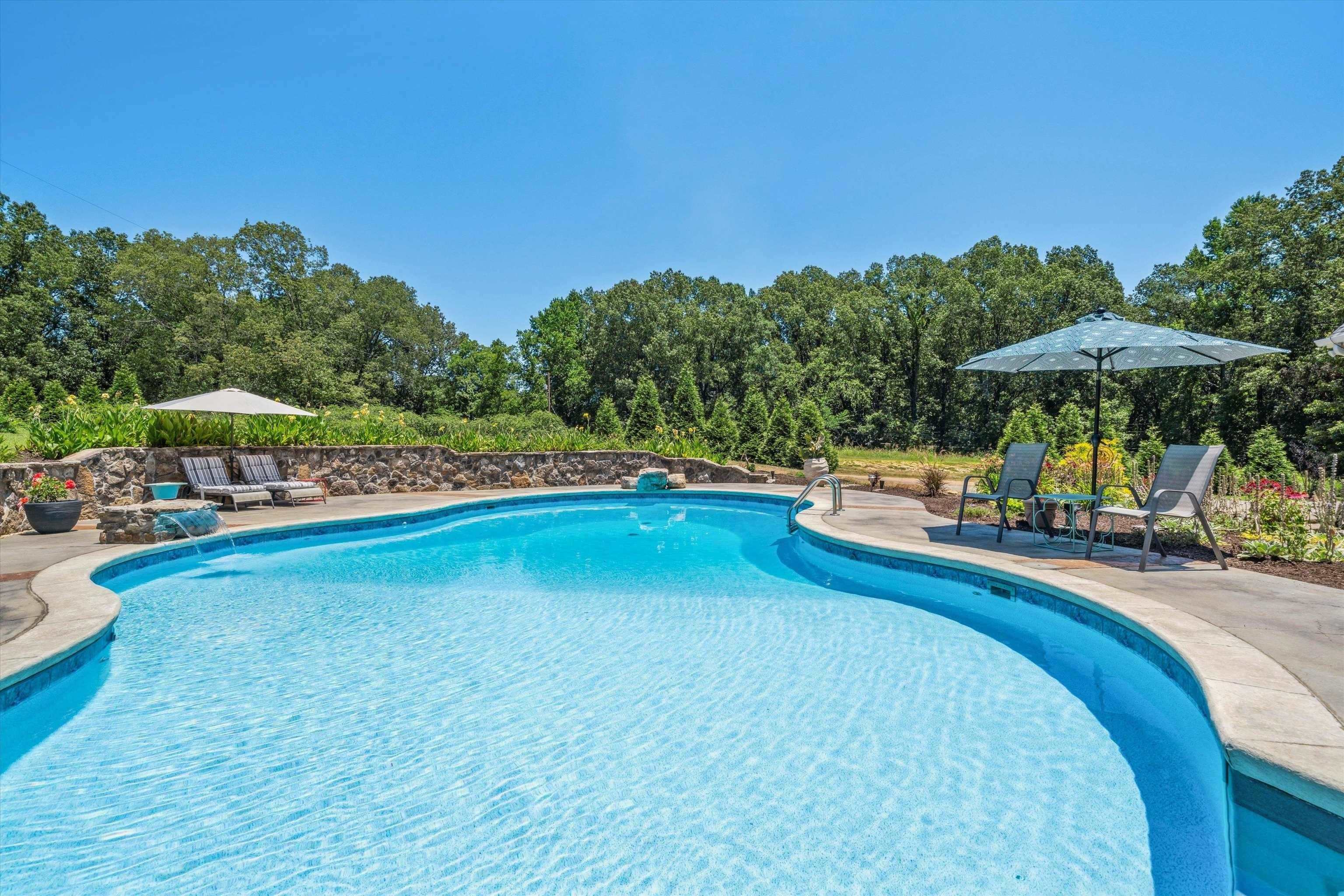 897 Burrowtown Road Mason, TN 38049 - Photo 34 of 36 Swimming pool with a patio area and view of scattered trees