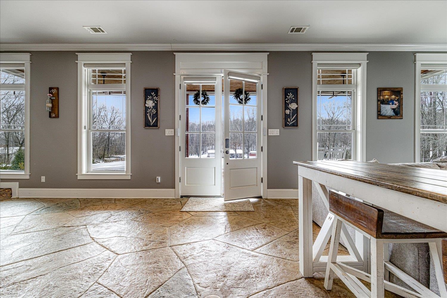 897 Burrowtown Road Mason, TN 38049 - Photo 4 of 36 Entrance foyer with light stone finish floors, ornamental molding, and french doors