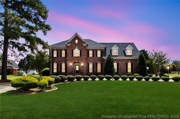 a front view of a house with a yard table and chairs