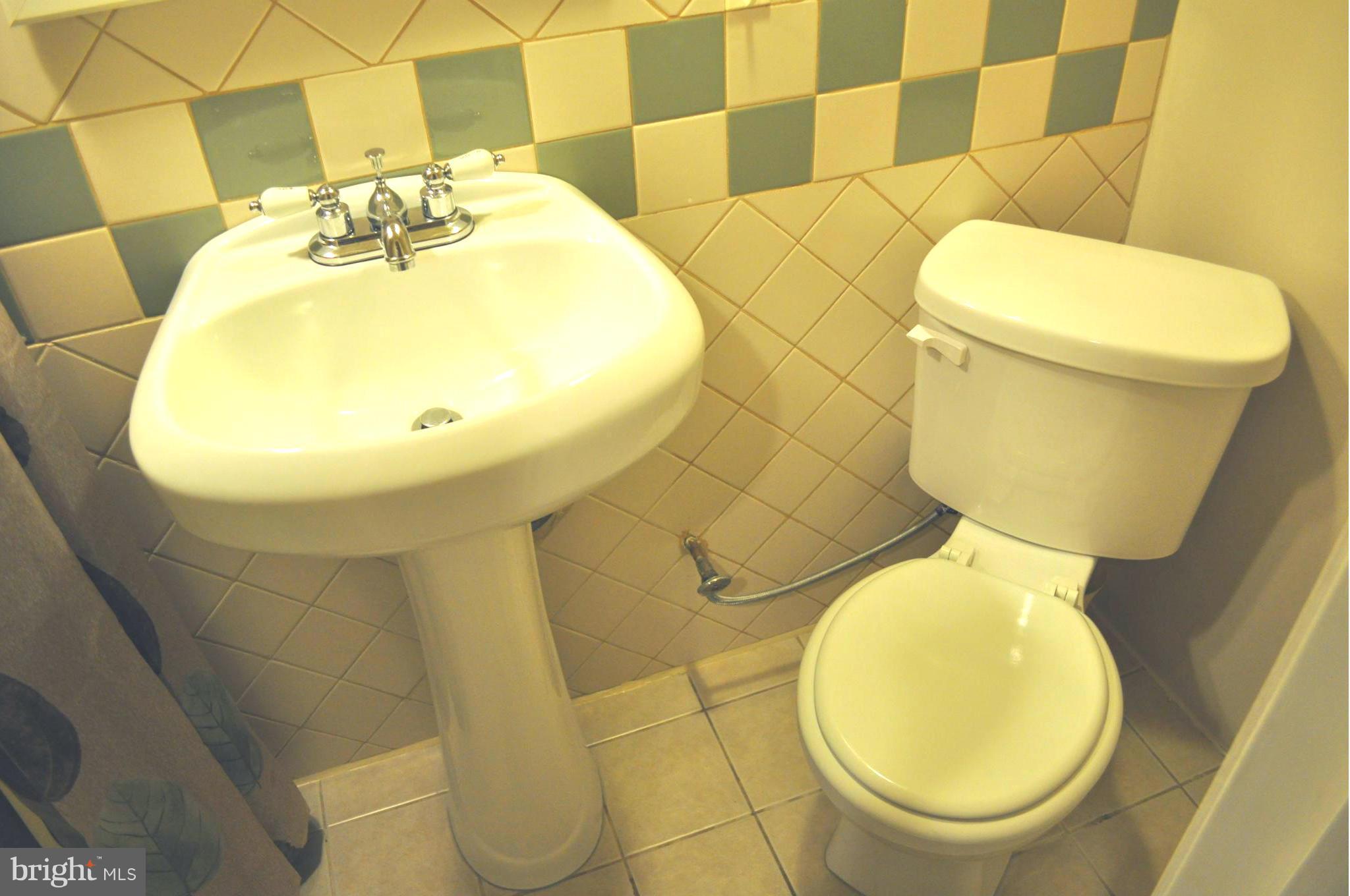 2041 Inverton Road Baltimore, MD 21222 - Photo 16 of 27 a bathroom with a toilet and a mirror