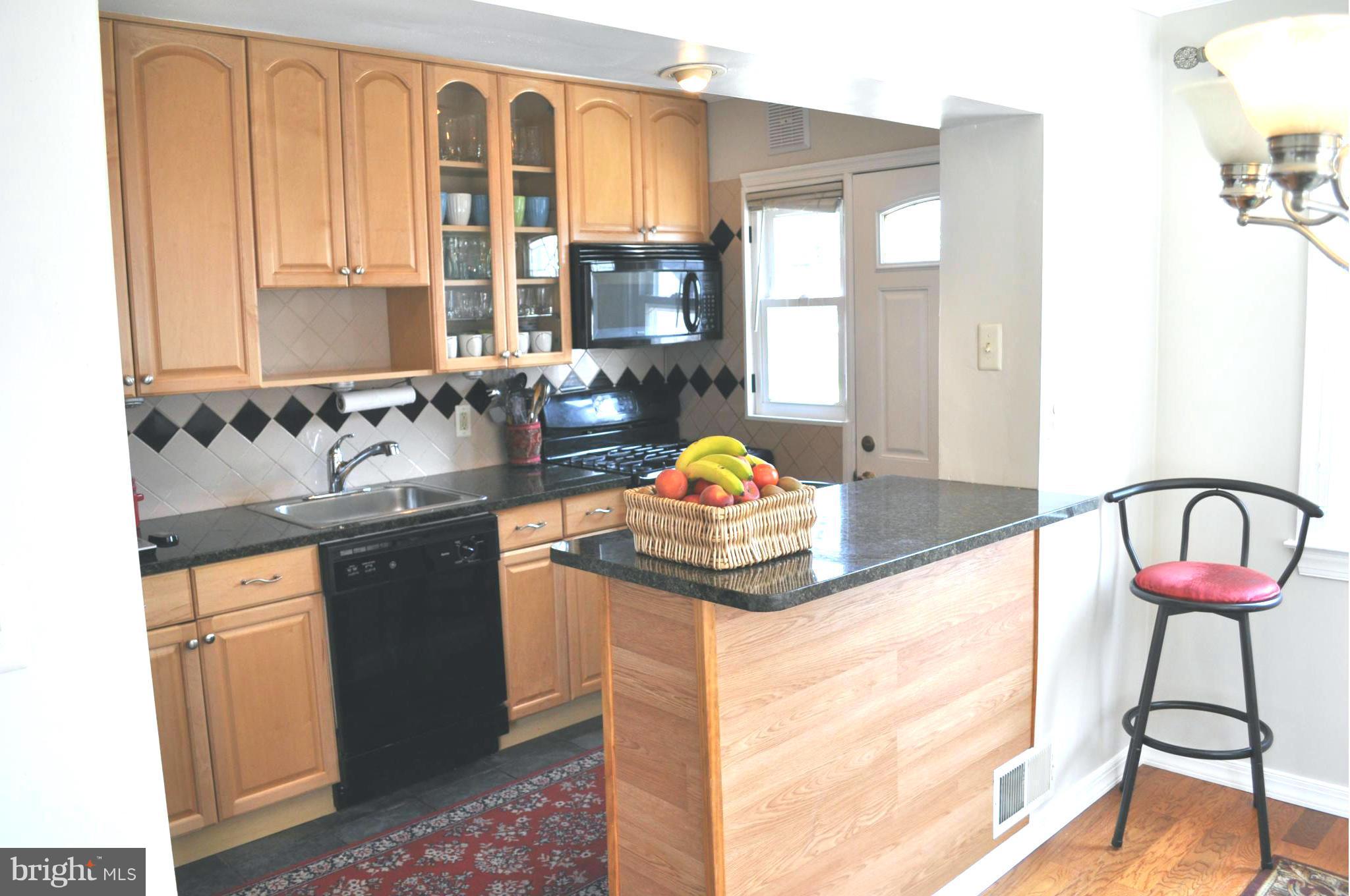 2041 Inverton Road Baltimore, MD 21222 - Photo 5 of 27 a bathroom with a granite countertop sink and a large mirror