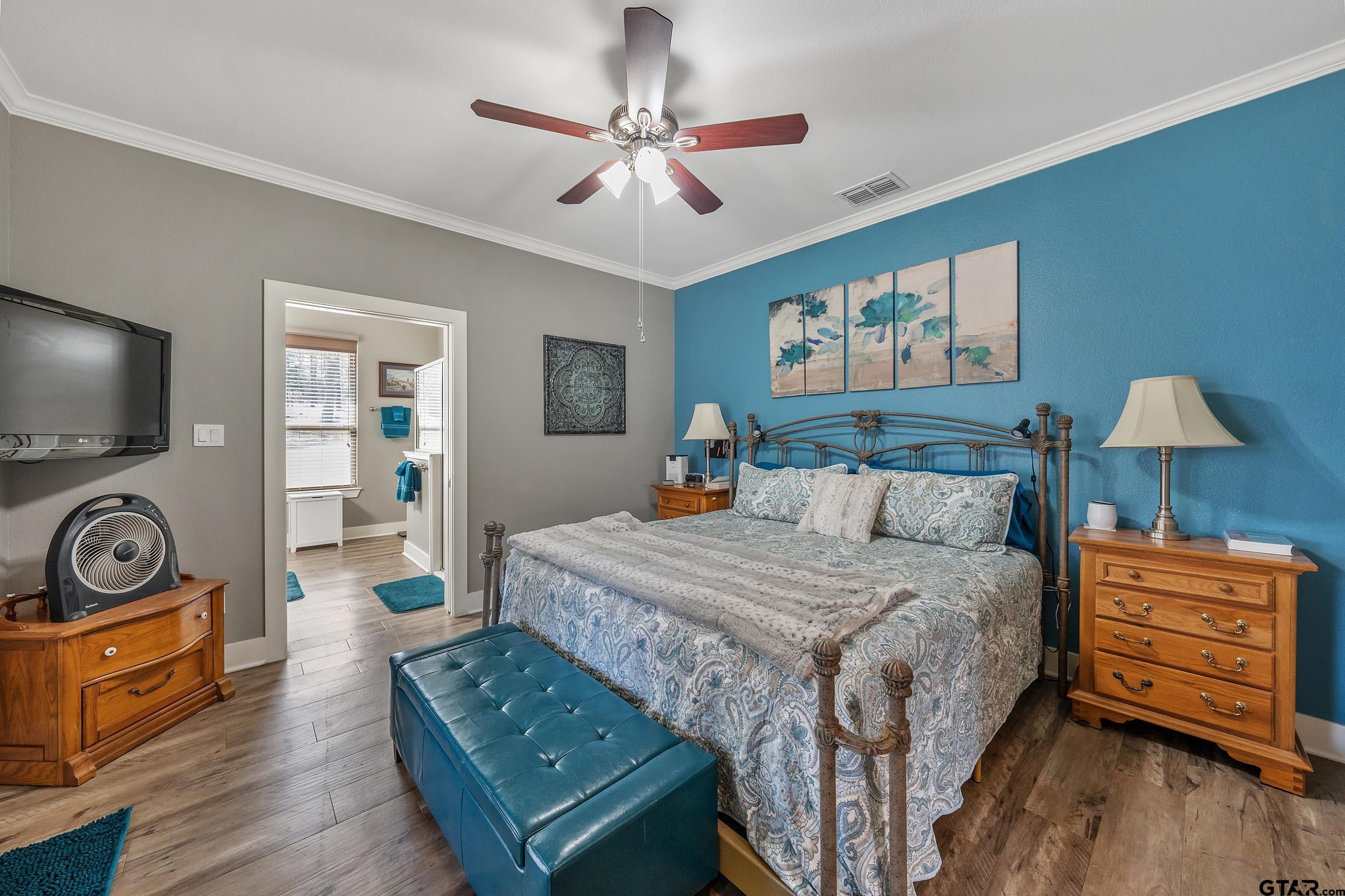 10918 Spring Club Lake Tyler, TX 75706 - Photo 11 of 23 a bedroom with a bed and wooden floor