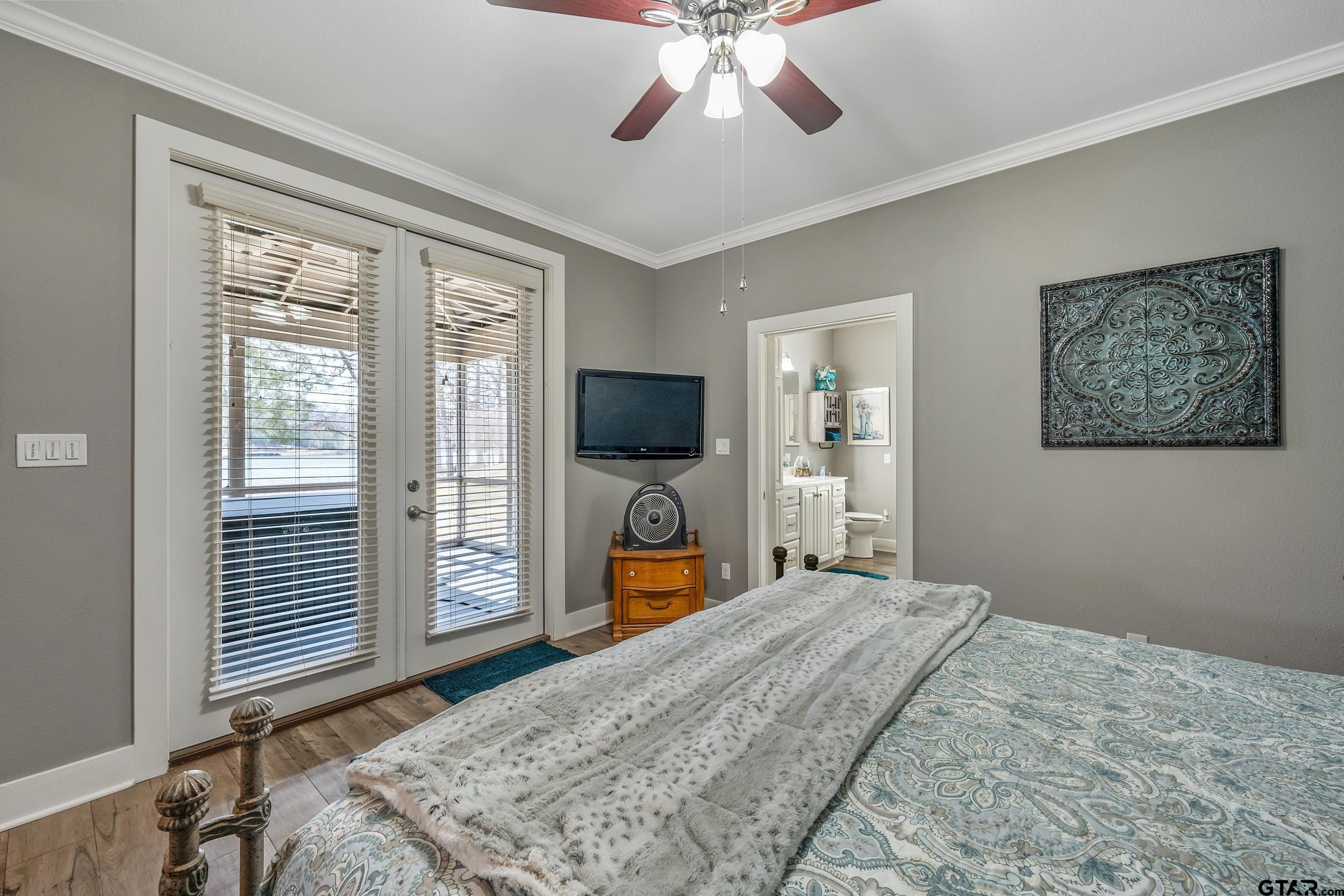 10918 Spring Club Lake Tyler, TX 75706 - Photo 12 of 23 a bedroom with a bed and a flat screen tv