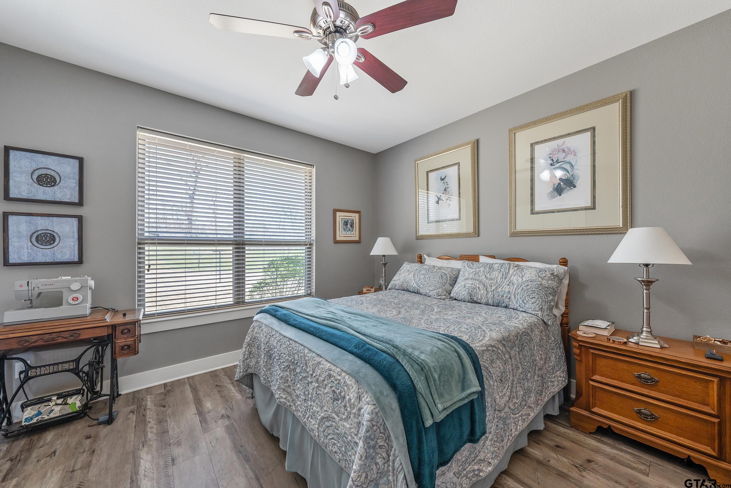 10918 Spring Club Lake Tyler, TX 75706 - Photo 15 of 23 a bedroom with a bed and a chandelier