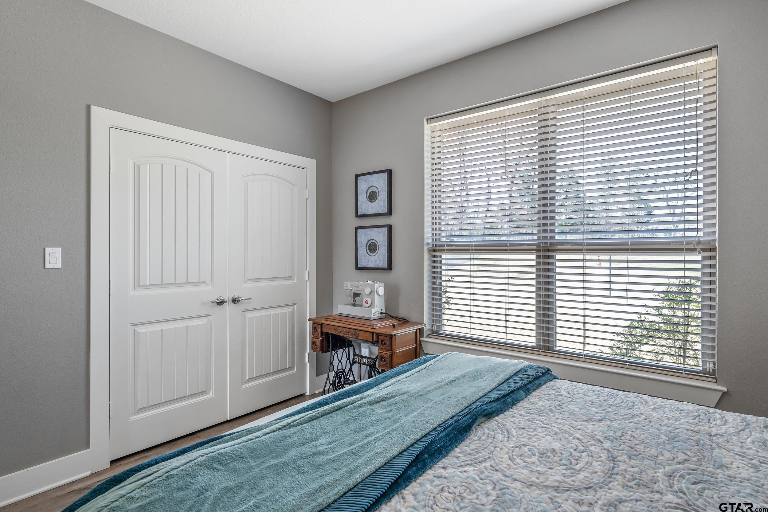 10918 Spring Club Lake Tyler, TX 75706 - Photo 16 of 23 a view of a bedroom with closet and windows