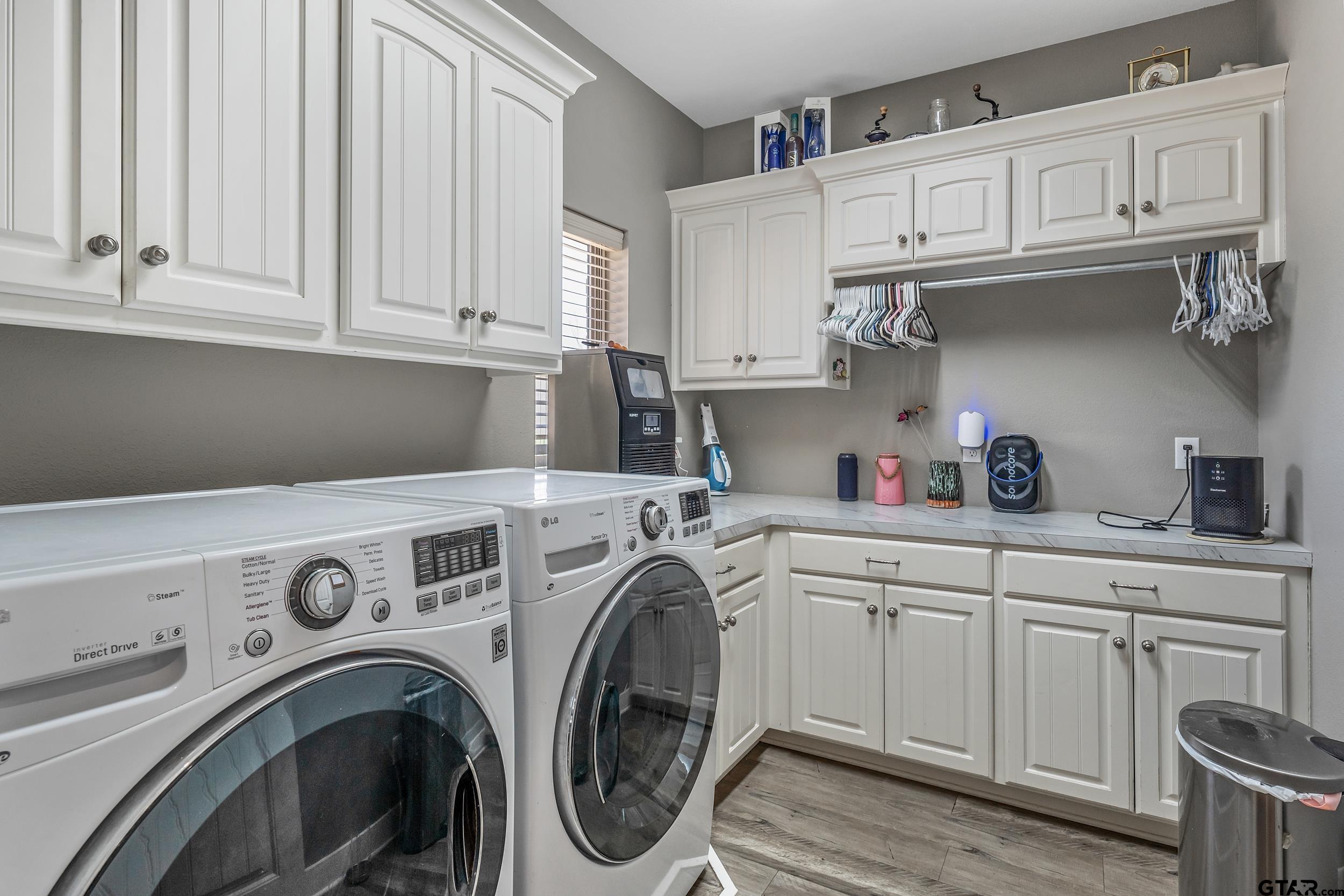 10918 Spring Club Lake Tyler, TX 75706 - Photo 17 of 23 a view of cabinets and washer dryer