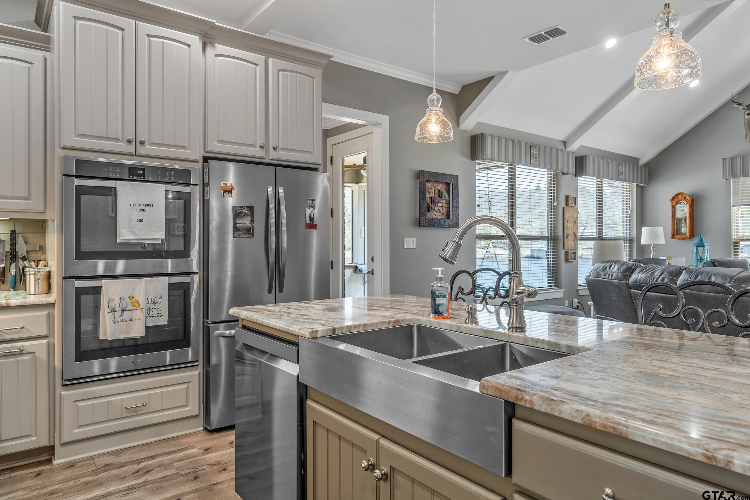 10918 Spring Club Lake Tyler, TX 75706 - Photo 19 of 23 a kitchen with stainless steel appliances granite countertop a sink a stove and a refrigerator with wooden floor