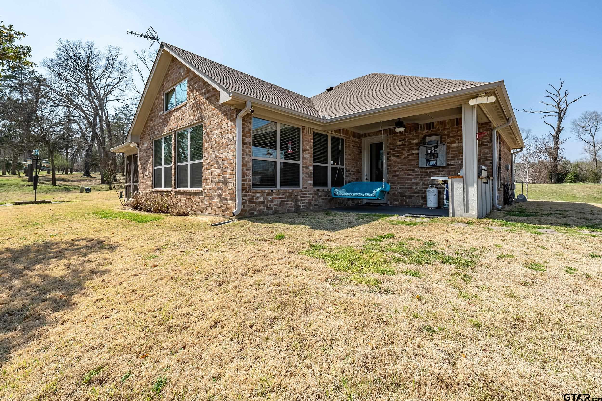 10918 Spring Club Lake Tyler, TX 75706 - Photo 21 of 23 a view of a house with a yard and sitting area