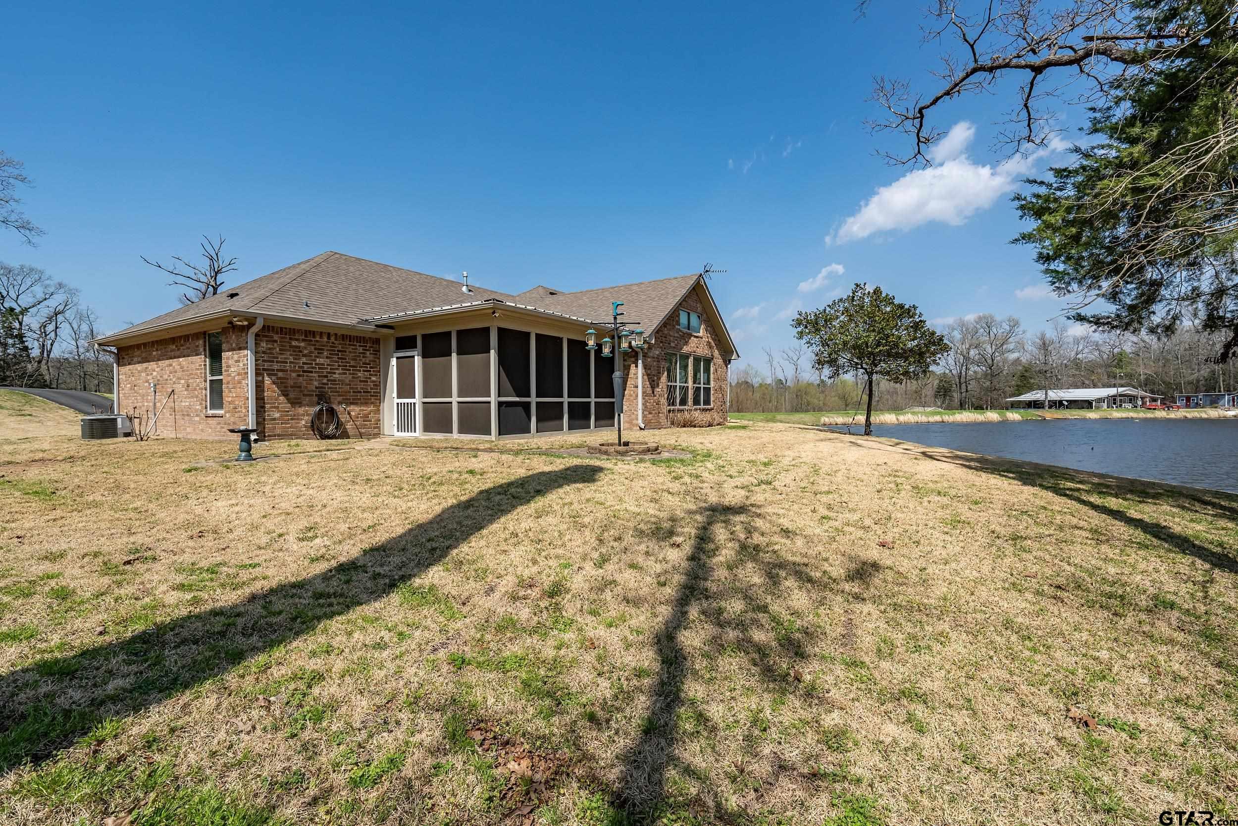 10918 Spring Club Lake Tyler, TX 75706 - Photo 22 of 23 a front view of a house with a yard