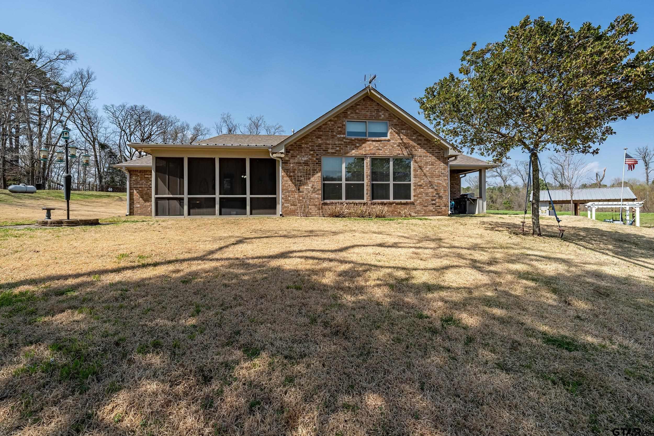 10918 Spring Club Lake Tyler, TX 75706 - Photo 6 of 23 a front view of a house with a yard