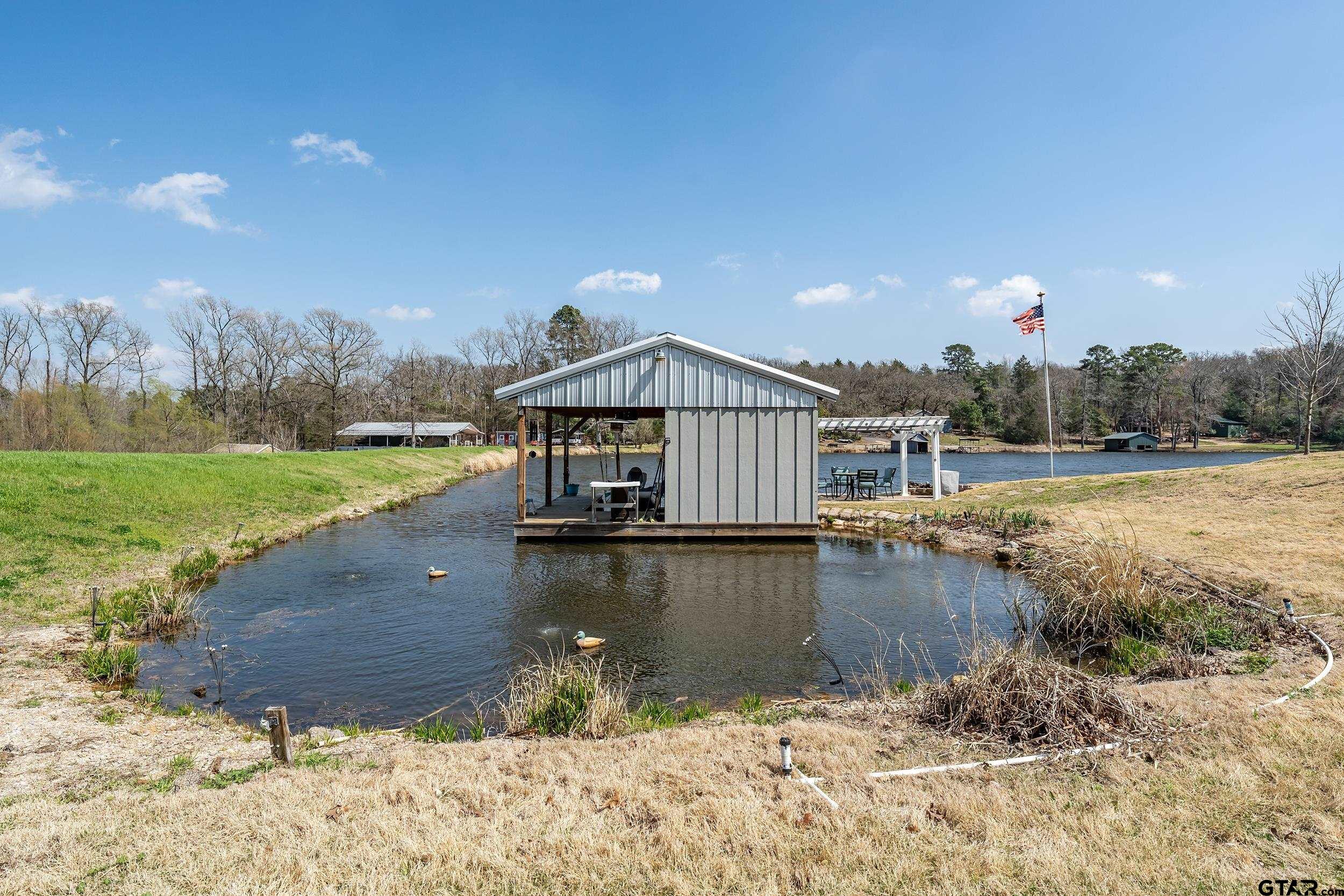 10918 Spring Club Lake Tyler, TX 75706 - Photo 7 of 23 a view of a house with a lake view